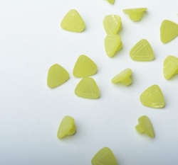 Knoflík ve tvaru trojúhelníku, po stranách rýhovaný zelený