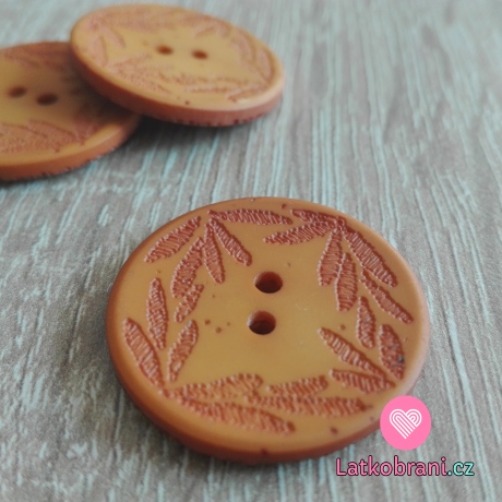 Knoflík s vyrytými lístečky oranžový
