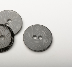 Knoflík kulatý, hladký černý s vyrytými ornamenty, dvojí lesk